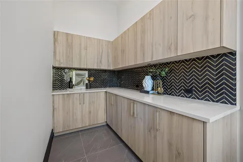 a open kitchen with white cabinets and stainless steel appliances