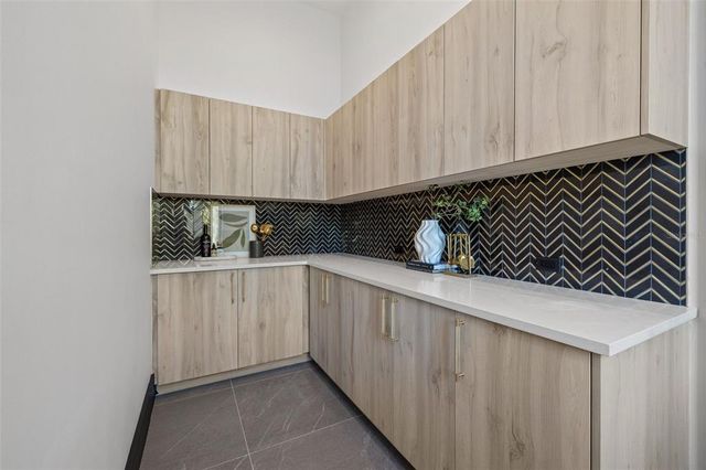 a open kitchen with white cabinets and stainless steel appliances
