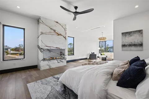 a living room with patio furniture and a potted plant