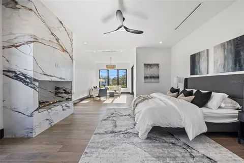 a view of a chairs and table on the wooden roof deck