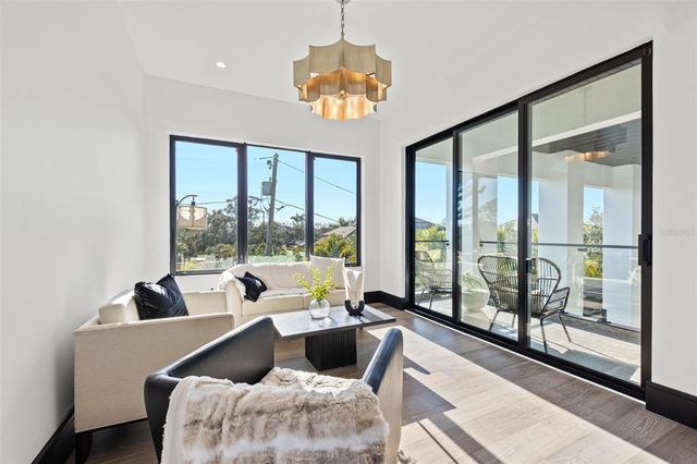 a view of house with swimming pool and trees in the background
