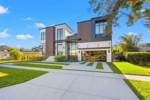 a view of backyard with swimming pool and seating space