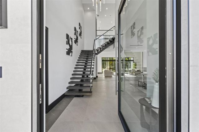 a living room with furniture a rug and white walls