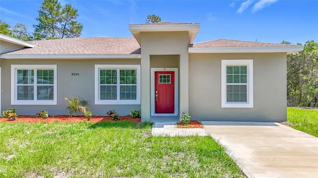 a front view of a house with a yard and porch
