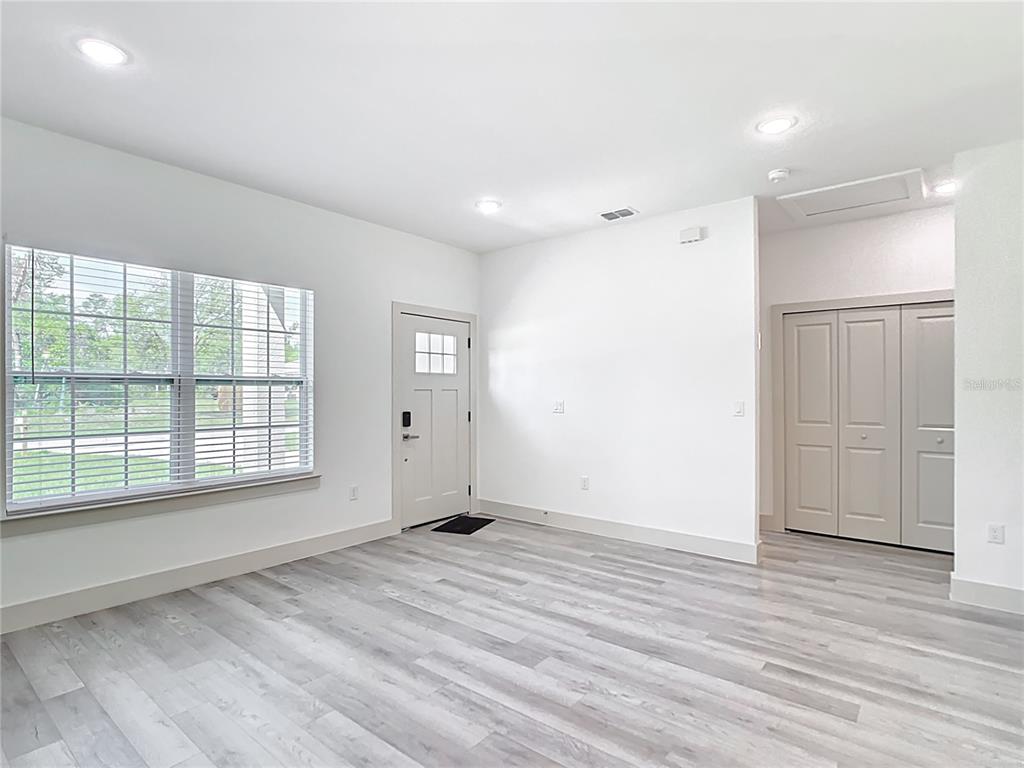3525 Southwest 163rd Pl Road Ocala, FL 34473 - Photo 15 of 80 a view of an empty room with wooden floor and a window