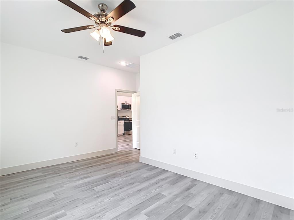 3525 Southwest 163rd Pl Road Ocala, FL 34473 - Photo 21 of 80 a view of an empty room with a fan