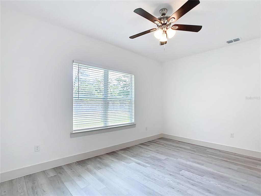 3525 Southwest 163rd Pl Road Ocala, FL 34473 - Photo 23 of 80 an empty room with a window and a fan
