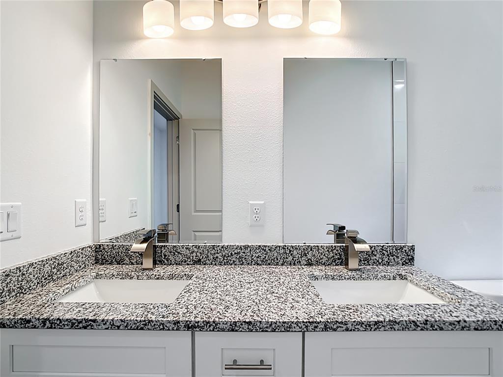 3525 Southwest 163rd Pl Road Ocala, FL 34473 - Photo 27 of 80 a bathroom with a granite countertop sink and a mirror