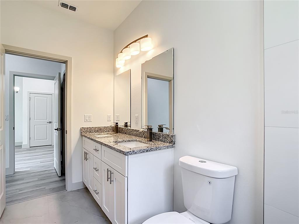 3525 Southwest 163rd Pl Road Ocala, FL 34473 - Photo 28 of 80 a spacious bathroom with a granite countertop sink and a mirror