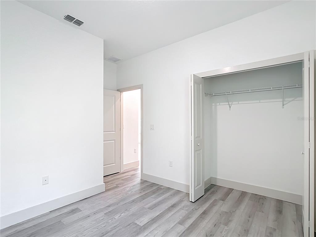 3525 Southwest 163rd Pl Road Ocala, FL 34473 - Photo 29 of 80 a view of an empty room with wooden floor