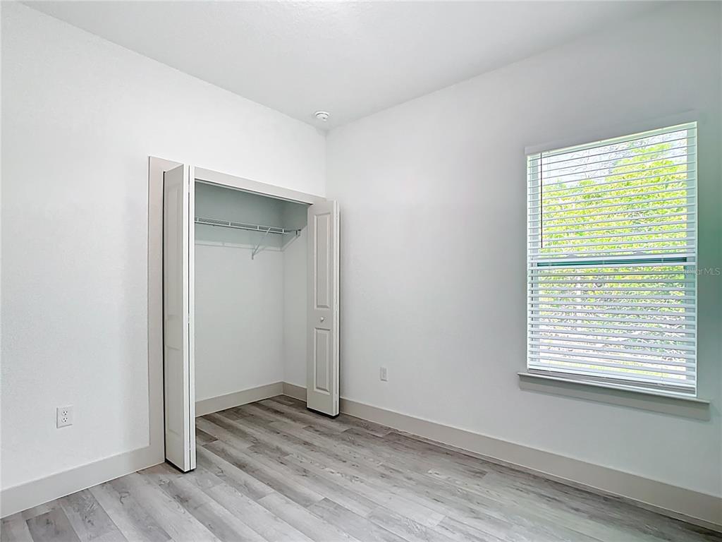 3525 Southwest 163rd Pl Road Ocala, FL 34473 - Photo 31 of 80 a view of an empty room with wooden floor and a window