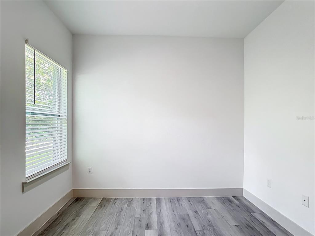 3525 Southwest 163rd Pl Road Ocala, FL 34473 - Photo 32 of 80 a view of a room that has wooden floor and windows in it
