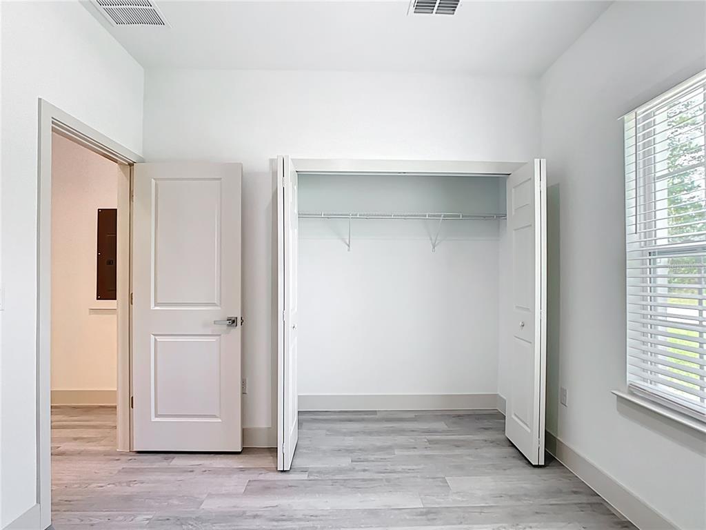3525 Southwest 163rd Pl Road Ocala, FL 34473 - Photo 35 of 80 a view of an empty room with wooden floor and a window