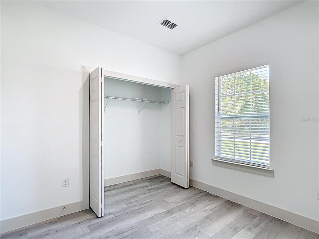 3525 Southwest 163rd Pl Road Ocala, FL 34473 - Photo 38 of 80 a view of an empty room with wooden floor and a window