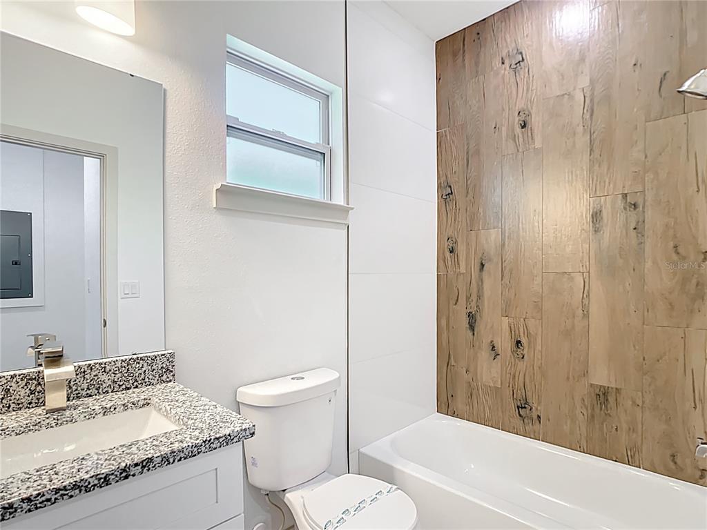 3525 Southwest 163rd Pl Road Ocala, FL 34473 - Photo 39 of 80 a bathroom with a granite countertop sink a toilet and shower