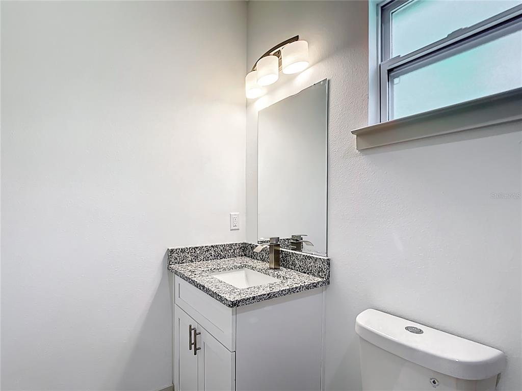 3525 Southwest 163rd Pl Road Ocala, FL 34473 - Photo 40 of 80 a bathroom with a granite countertop sink and a mirror