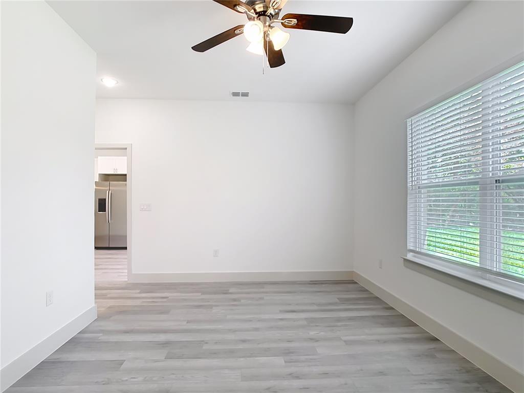 3525 Southwest 163rd Pl Road Ocala, FL 34473 - Photo 48 of 80 a view of an empty room with wooden floor and a window