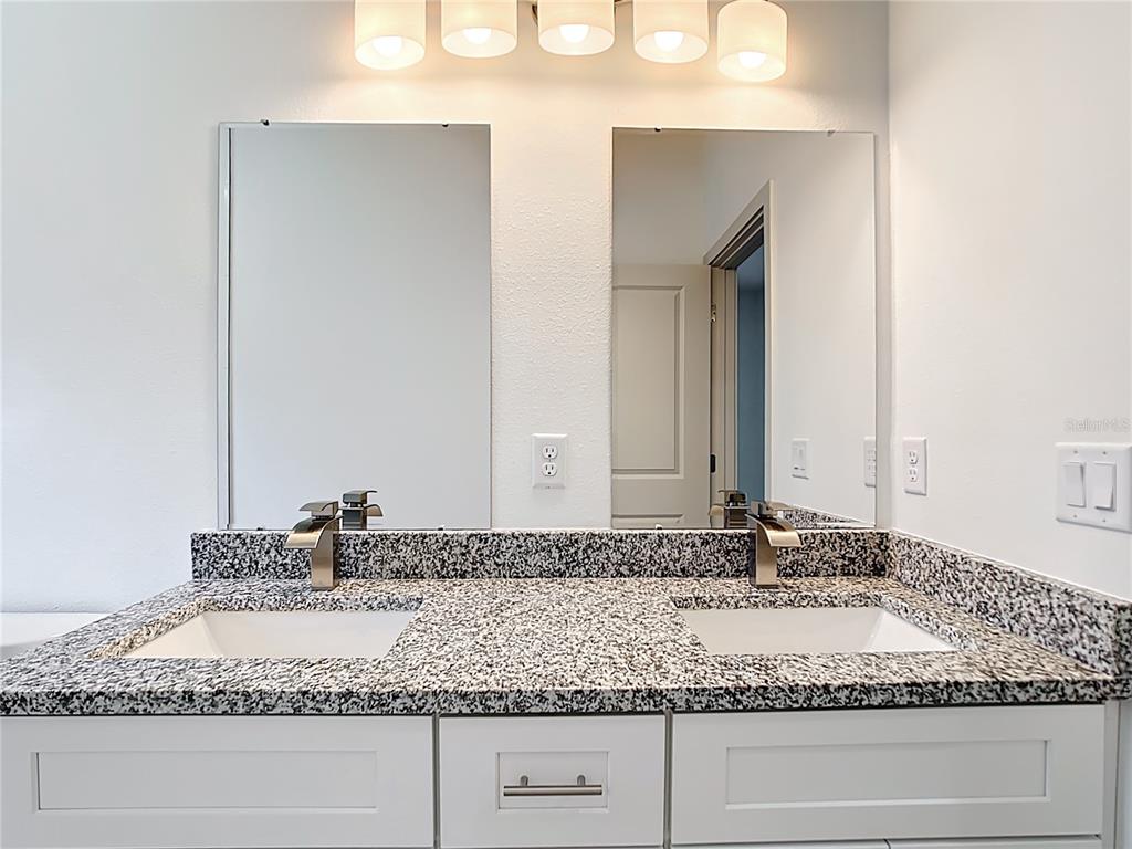 3525 Southwest 163rd Pl Road Ocala, FL 34473 - Photo 53 of 80 a bathroom with a granite countertop sink and mirror