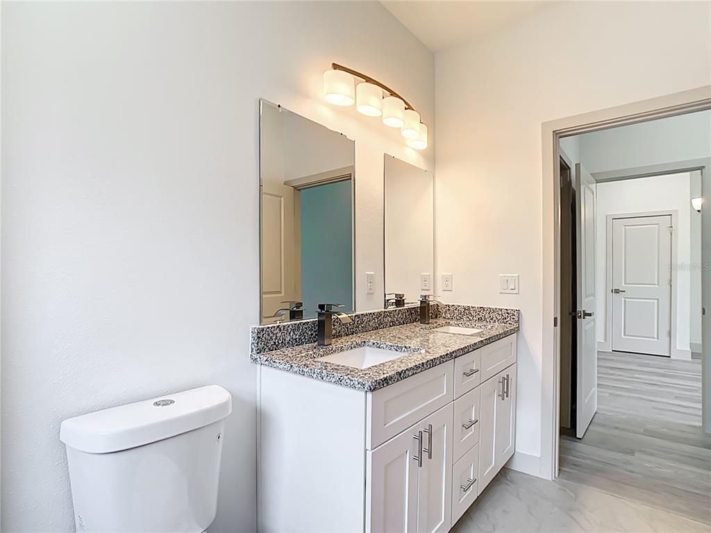 3525 Southwest 163rd Pl Road Ocala, FL 34473 - Photo 54 of 80 a bathroom with a granite countertop sink and a mirror