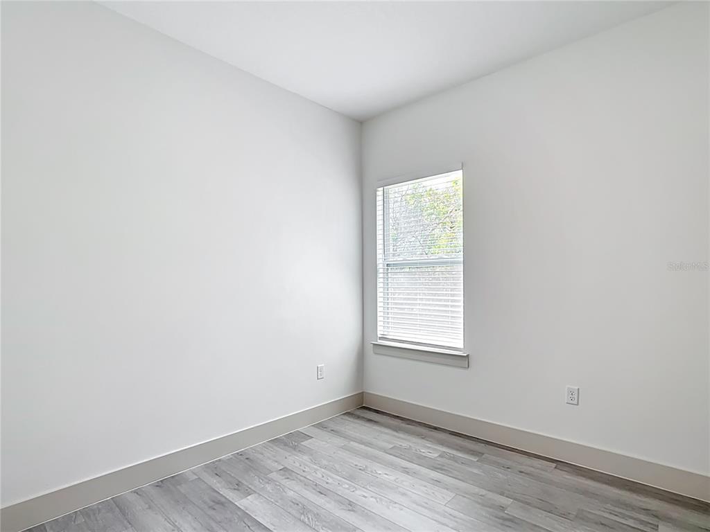 3525 Southwest 163rd Pl Road Ocala, FL 34473 - Photo 55 of 80 an empty room with wooden floor and windows