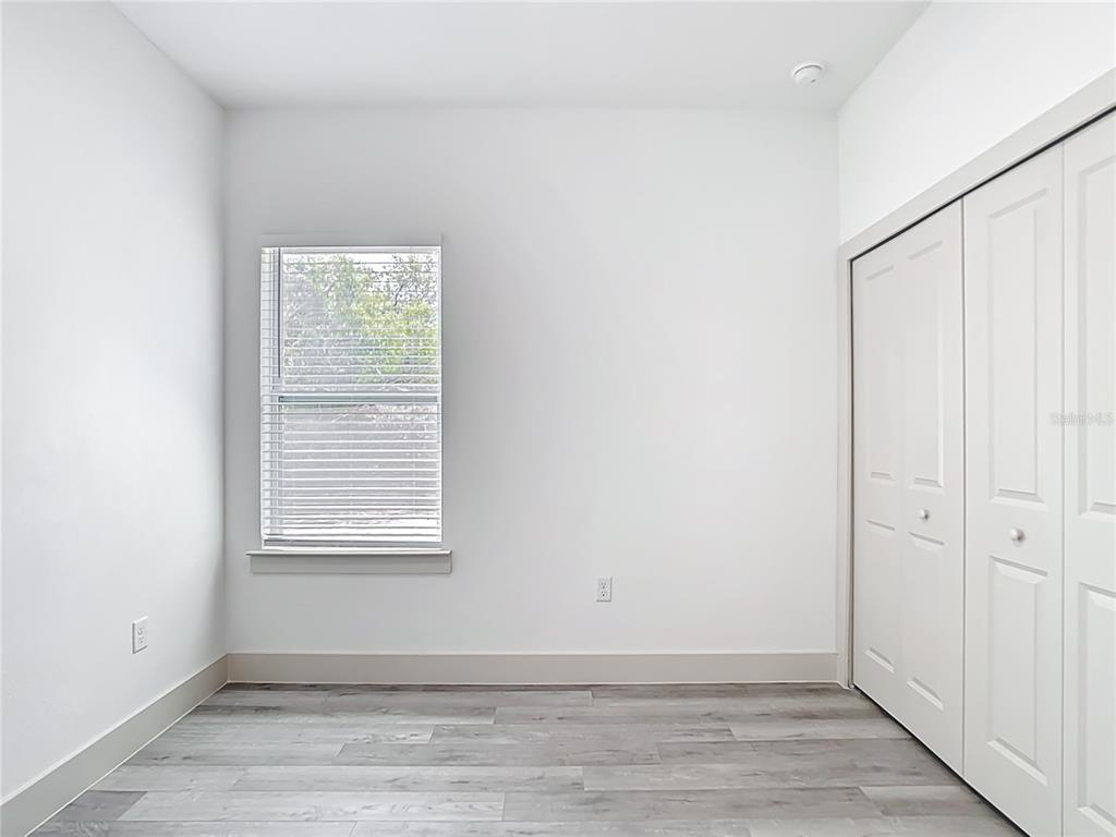 3525 Southwest 163rd Pl Road Ocala, FL 34473 - Photo 56 of 80 an empty room with wooden floor and windows