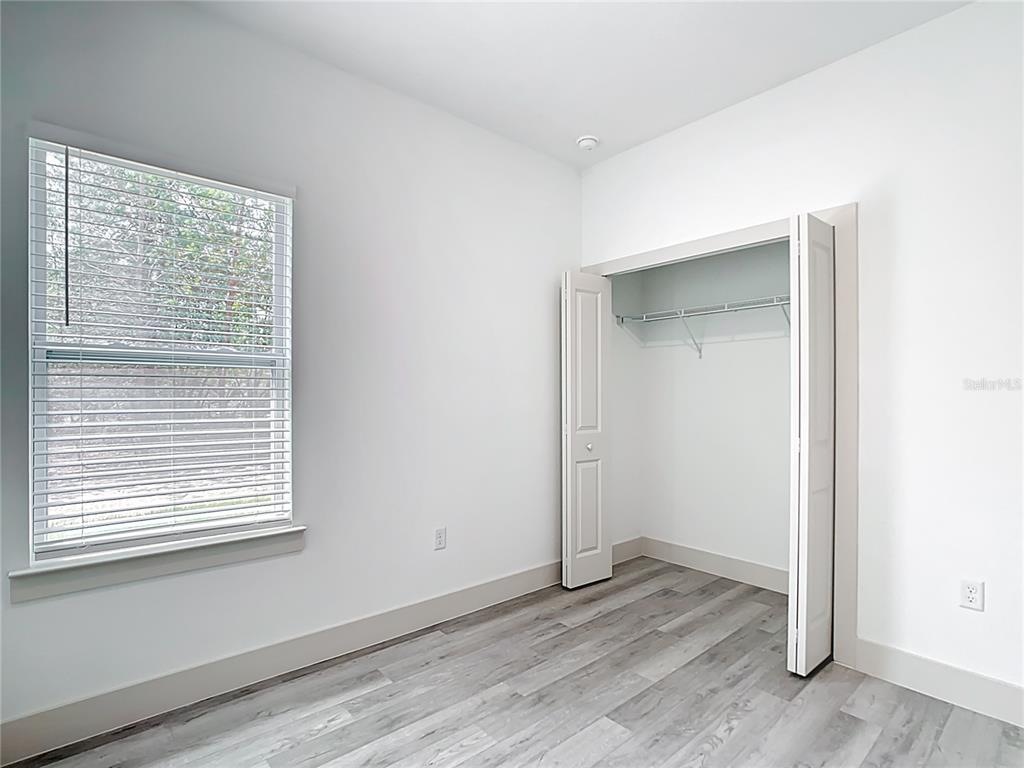 3525 Southwest 163rd Pl Road Ocala, FL 34473 - Photo 57 of 80 a view of an empty room with wooden floor and a window
