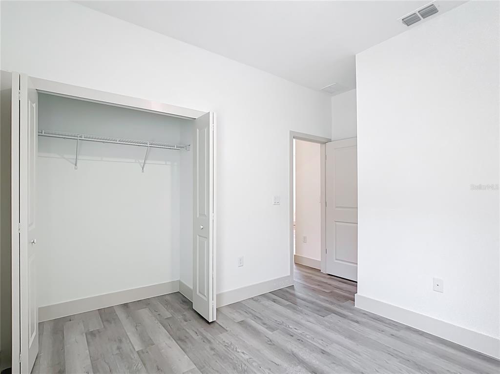 3525 Southwest 163rd Pl Road Ocala, FL 34473 - Photo 58 of 80 a view of an empty room with wooden floor and closet
