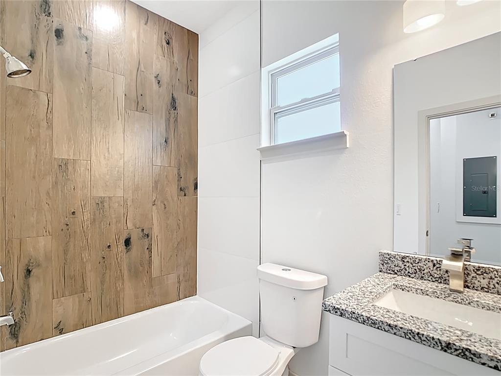 3525 Southwest 163rd Pl Road Ocala, FL 34473 - Photo 64 of 80 a bathroom with a granite countertop sink toilet and shower