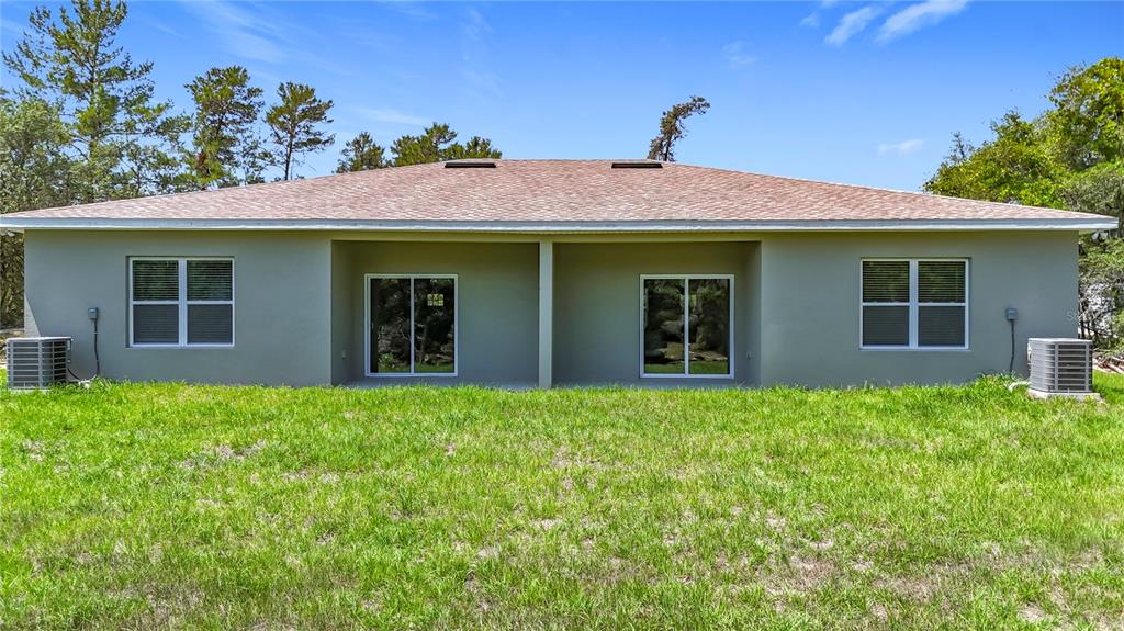 3525 Southwest 163rd Pl Road Ocala, FL 34473 - Photo 68 of 80 a front view of a house with yard