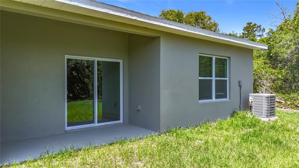 3525 Southwest 163rd Pl Road Ocala, FL 34473 - Photo 69 of 80 a front view of a house with a yard