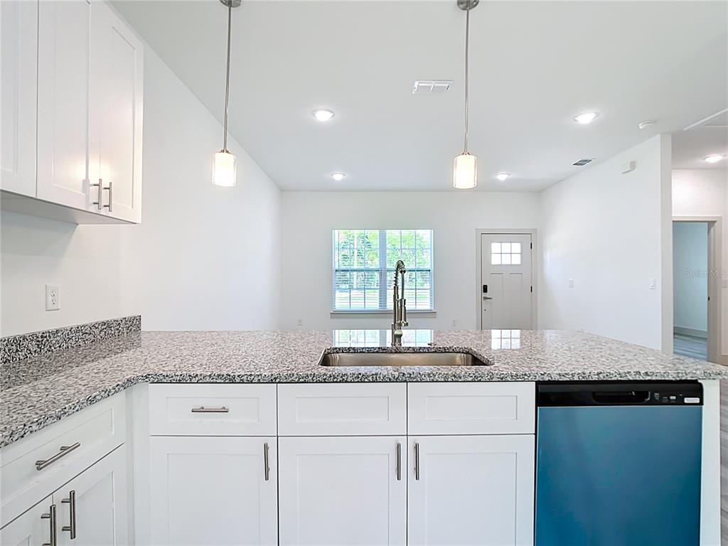 3525 Southwest 163rd Pl Road Ocala, FL 34473 - Photo 9 of 80 a kitchen with granite countertop cabinets and window
