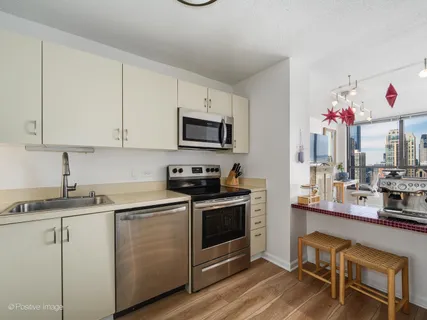 a kitchen with cabinets a sink and appliances