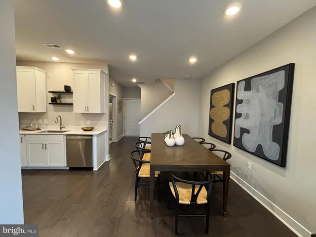 a open kitchen with stainless steel appliances granite countertop a sink a stove and wooden floor