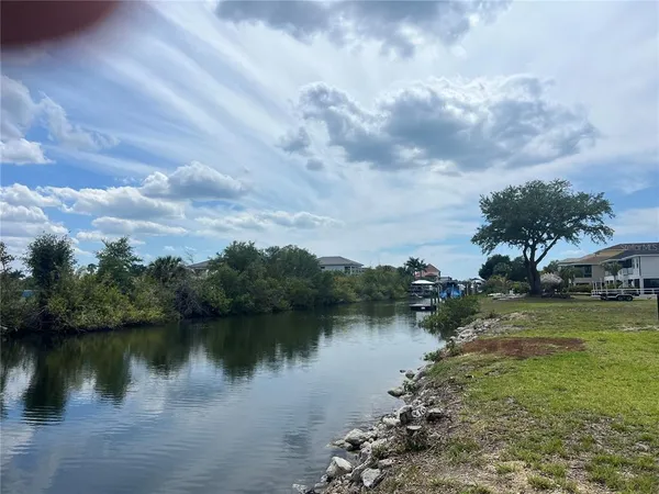 a view of a lake with houses in the back
