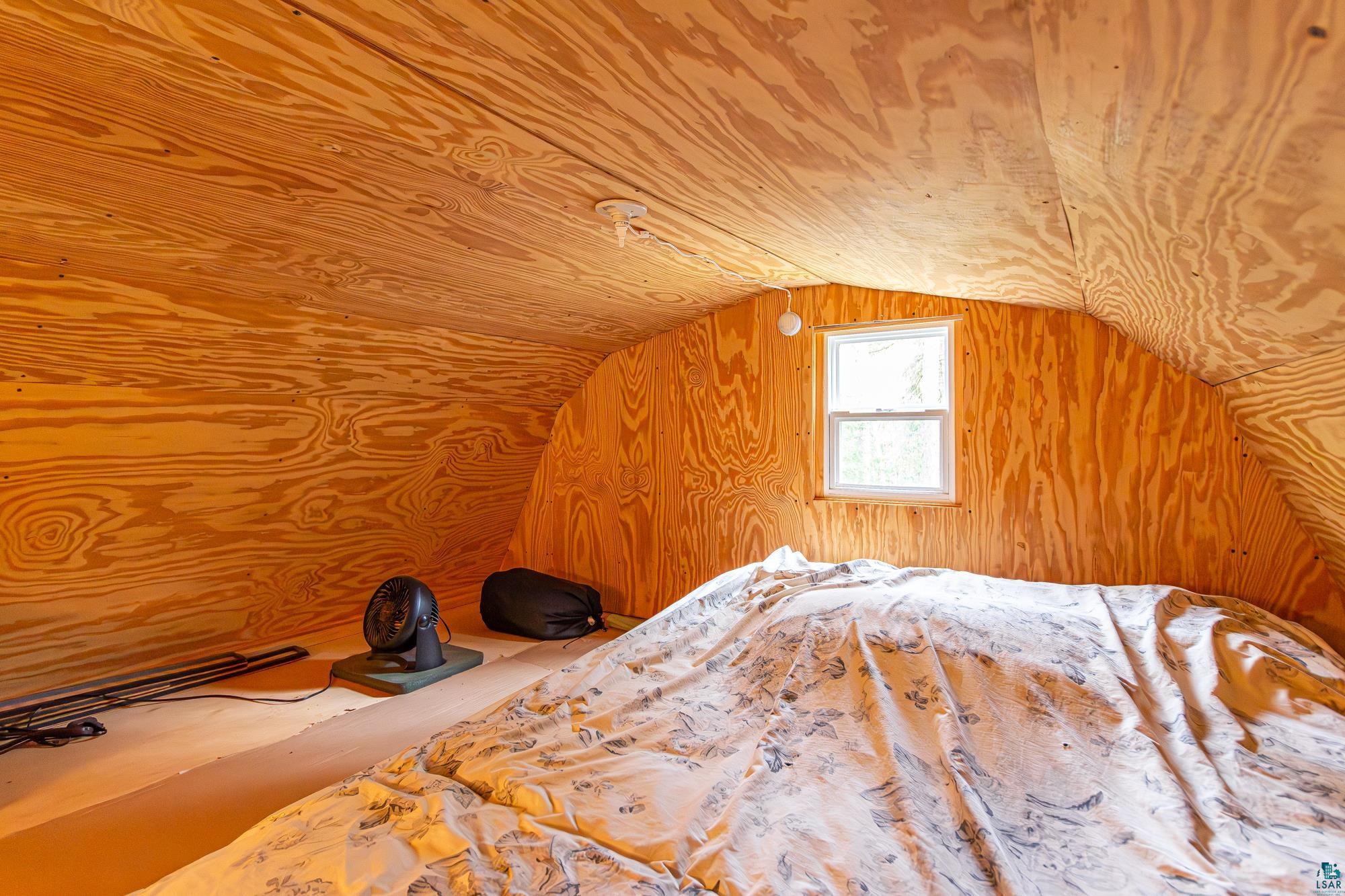 2260 Gold Mine Road Ely, MN 55731 - Photo 8 of 29 Unfurnished bedroom with vaulted ceiling and wood walls