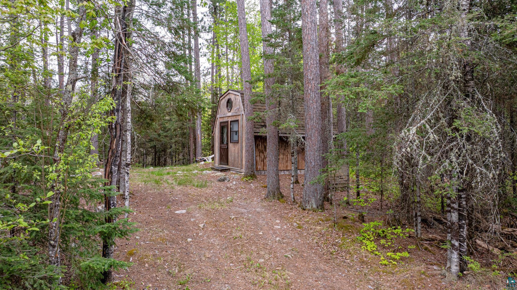 2260 Gold Mine Road Ely, MN 55731 - Photo 10 of 29 View of front facade featuring an outbuilding and a forest view