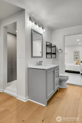 a bathroom with a double vanity sink mirror and toilet