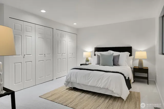 a bedroom with a bed and a night stand