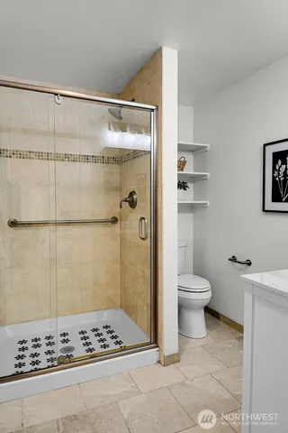 a bathroom with a toilet a shower and a sink