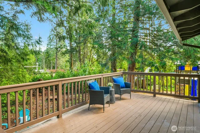 a view of balcony with wooden floor and seating