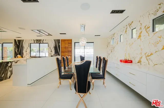 a bedroom with furniture and a large window