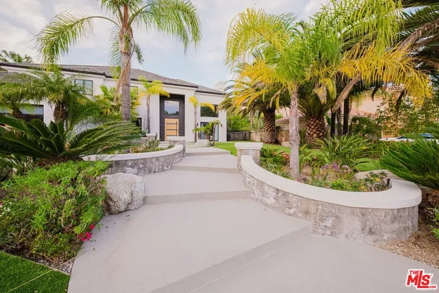 a view of a house with pool and sitting area