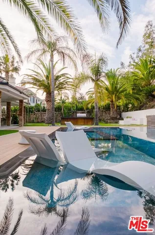 a spacious bedroom with a large bed and a dresser