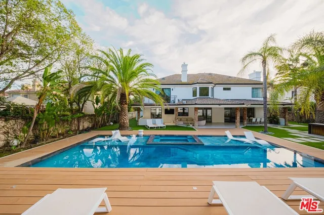 a living room with furniture and large windows