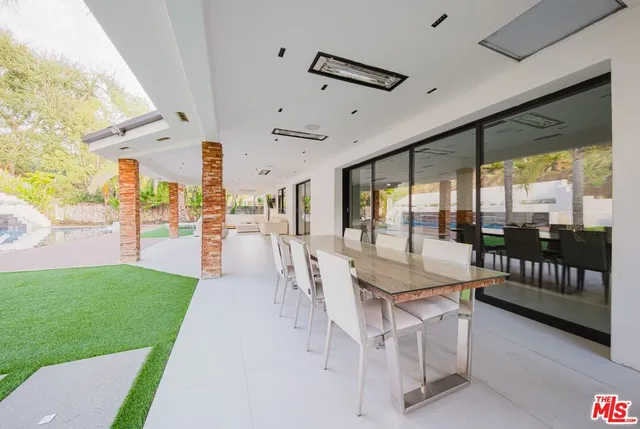 a bathroom with a granite countertop tub and a large window