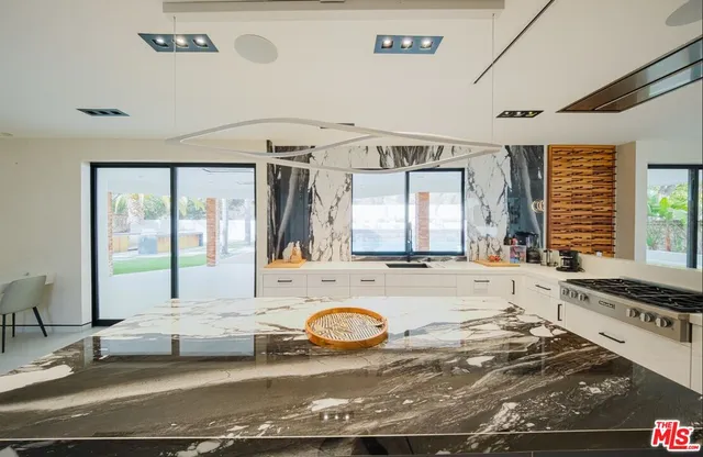 a view of a patio with table and chairs with wooden floor and fence