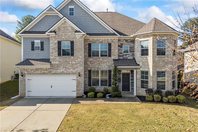 a kitchen with stainless steel appliances granite countertop refrigerator sink and cabinets