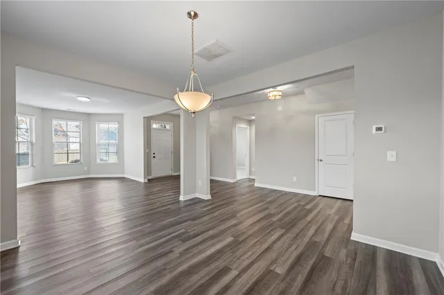 a kitchen with kitchen island granite countertop a large counter and stainless steel appliances