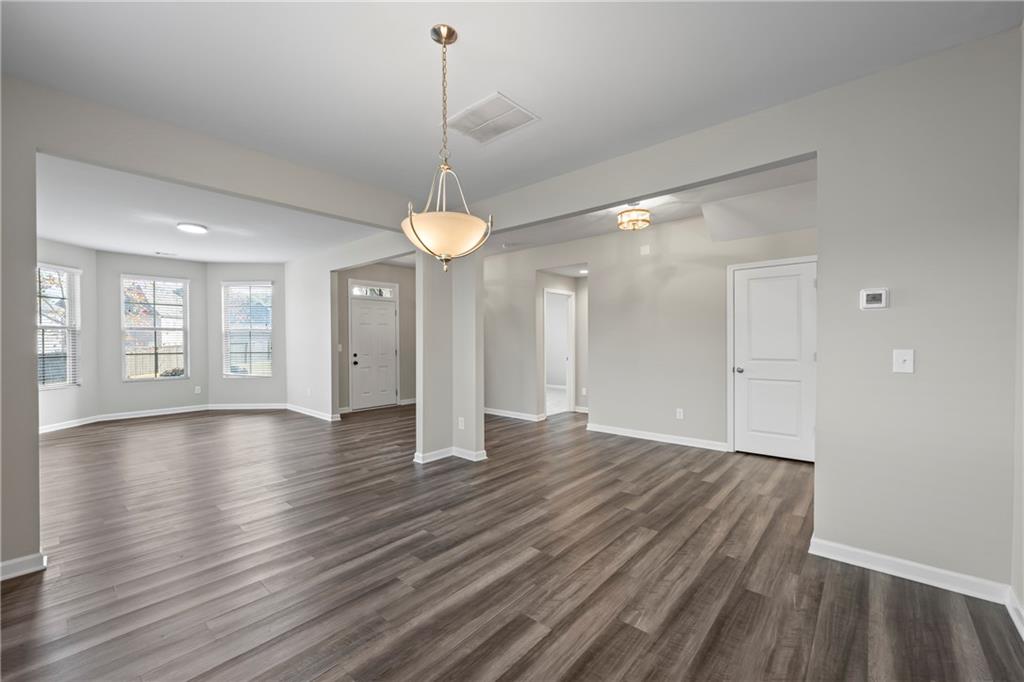 30 Fanleaf Drive Fairburn, GA 30213 - Photo 12 of 88 a view of an empty room with window and wooden floor