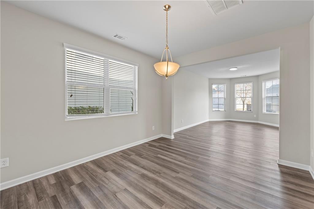 30 Fanleaf Drive Fairburn, GA 30213 - Photo 13 of 88 a view of an empty room with wooden floor and a window